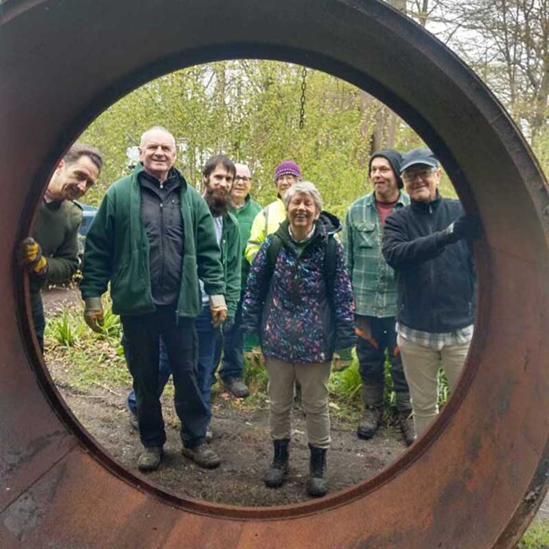 Volunteers celebrating the arrival of the 60 Acre Wood charcoal kiln