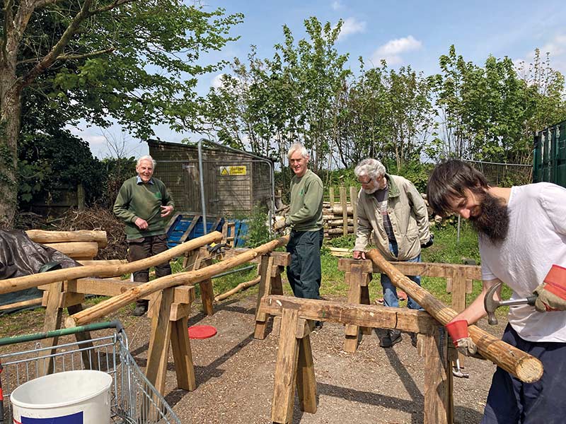 Lower Mole volunteers preparing new wood fence posts